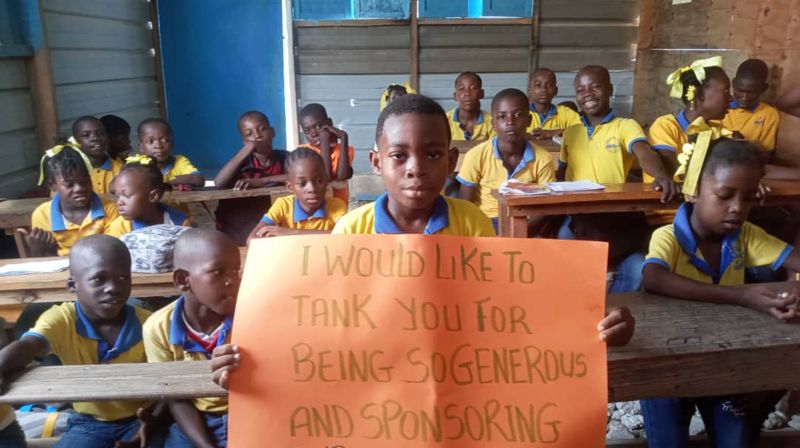 Een jongen van EMNJ-2 in Galette met een bord: I would like to thank you for being so generous and sponsoring us.